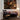 Living room with a painting on the wall, a rocking chair, and a lamp.
