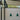 Two green pendant lights hanging from the ceiling in a modern interior setting.
