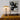 Vintage-style lamp on a wooden cabinet with abstract art in the background
