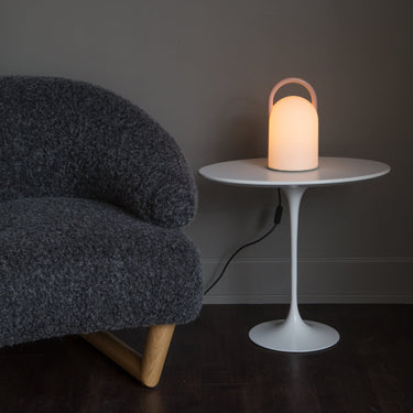 pink handle glass table lamp in midcentury room lit up