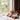 Two teddy bears sitting on a windowsill with a lamp and curtains in the background kids room lighting