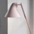 Pink table lamp against a light gray wall