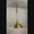 Brass farmhouse style pendant lamp on a grey background video