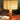 Table lamp with wooden base and striped shade on a wooden surface.