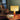 Table lamp on a wooden surface with a cozy room setting