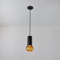 Pendant light with amber glass shade on a gray background