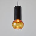 Pendant light with black cylindrical fixture and amber glass bulb on a gray background