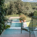 Outdoor setting with a pool, lounge chair, and scenic background