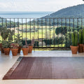 tonal outdoor rug on a patio overlooking the ocean