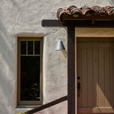 ZUZU Silver Painted wall sconce on spanish style entry way