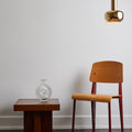 standard chair with vl56 pendant and tynell glass vase against a white wall