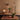 Modern interior with a wooden chair, small round table, and decorative items on a patterned rug for Two Enlighten 1960s Glass and Copper Pendant Attributed to Stilnovo