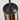 Close-up of a vintage stilnovo pendant with a black top and gold base on a white background with original label