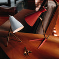 a pair of white and red vintage table lamps from the 1950s on a wood table