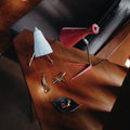 white ochetta table lamp and red stilux table lamp styled with aubock brass pieces on a wood table
