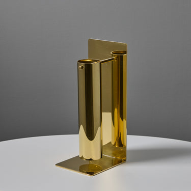 brass metal vase on a gray background