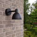 black modern outdoor wall light on brick wall toldbod louis poulsen model