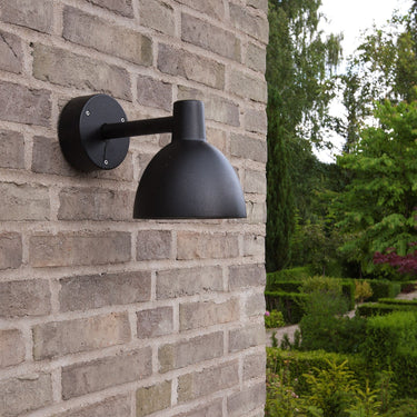 black modern outdoor wall light on brick wall toldbod louis poulsen model