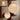 Two spherical pendant lights hanging in a room with wooden shelves and a brick wall.