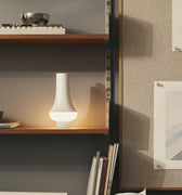 nendo studio tomoshi white lanters on modern book case with portable lighting