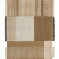 Textured woven rug with a patchwork design in earthy tones on a white background