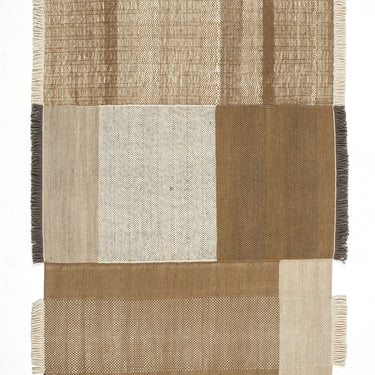 Textured woven rug with a patchwork design in earthy tones on a white background
