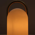 Lantern-style lamp with a warm glow on a dark background