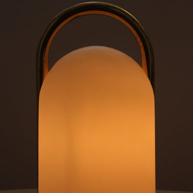 Lantern-style lamp with a warm glow on a dark background