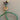 Green electrical cord with a plug on a gray surface