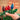 Hand holding Christmas light bulbs with a box of bulbs in the background