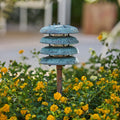 Decorative metal lantern among yellow flowers with a blurred garden background