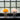 Two spherical lamps with wire bases in front of a glass block wall.