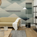 Modern living room with geometric wall mural, beige sofa, and floor lamp.