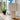 white textile plissé table lamp on a wooden surface with a blurred indoor background