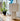 white textile plissé table lamp on a wooden surface with a blurred indoor background