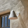 M5974 ZUZU White Painted wall sconce detail shot outside against stucco background