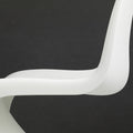 White curved chair on a black background